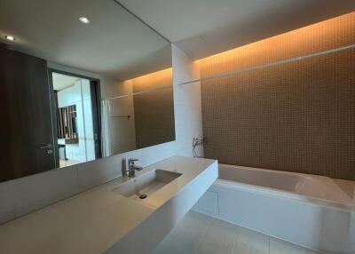 modern bathroom with large mirror and bathtub