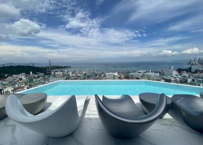 Rooftop infinity pool with a panoramic city and ocean view