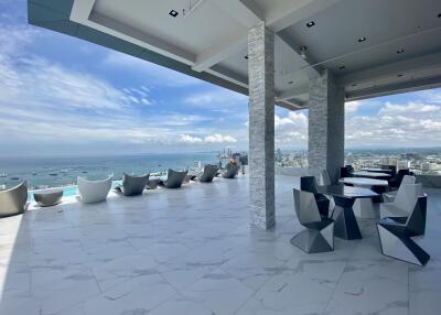 Rooftop terrace with seating area and ocean view