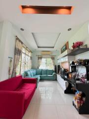 Spacious and well-lit living room with a combination of modern and traditional decor