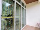 A patio area with decorative ironwork on glass doors