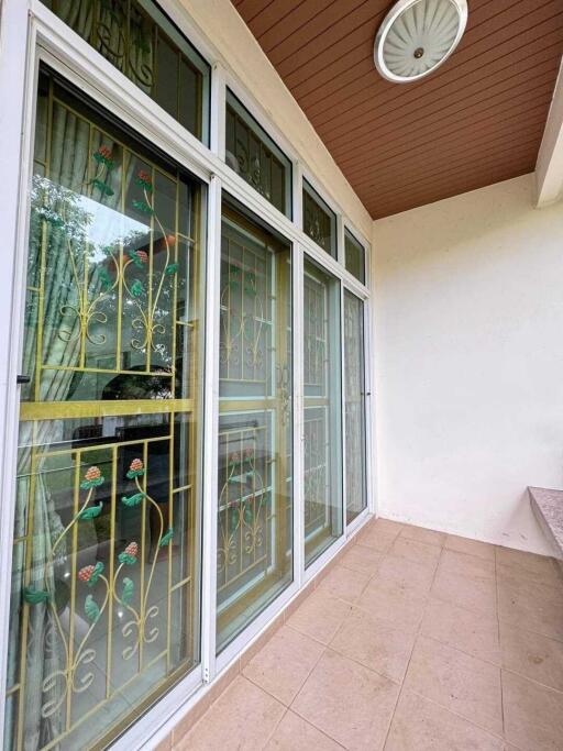 A patio area with decorative ironwork on glass doors