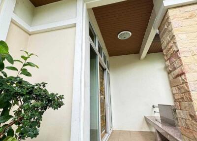 Exterior view of a modern entryway with landscaped plants