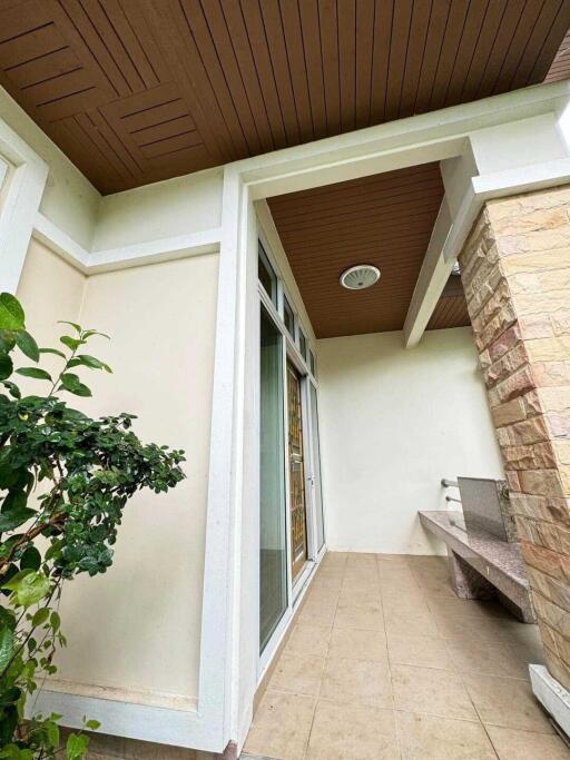 Exterior view of a modern entryway with landscaped plants