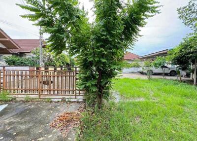 Front yard with driveway and wooden fence