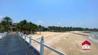 Beachfront view with palm trees and houses