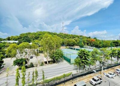 View of outdoor recreational area with tennis courts and greenery