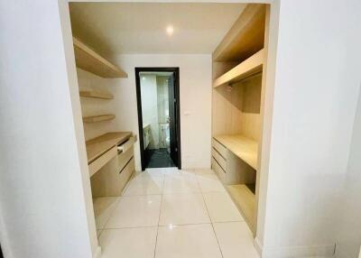 Spacious walk-in closet with built-in shelves and drawers