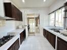 Modern kitchen with dark wood cabinetry and white countertops