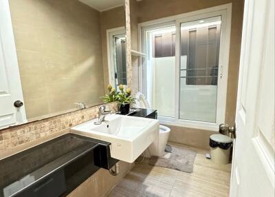 Modern bathroom with sink, mirror, and large window