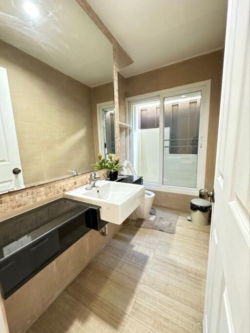 Modern bathroom with sink, mirror, and large window
