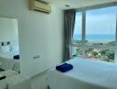 Bright bedroom with large window and sea view