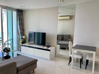 Modern living room with TV entertainment unit and dining area