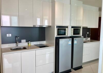 Modern kitchen with sleek white cabinets and stainless steel appliances