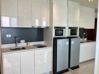 Modern kitchen with sleek white cabinets and stainless steel appliances