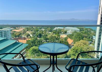 Balcony with a view of the ocean and surrounding buildings