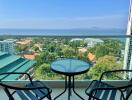 Balcony with a view of the ocean and surrounding buildings