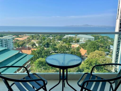 Balcony with a view of the ocean and surrounding buildings