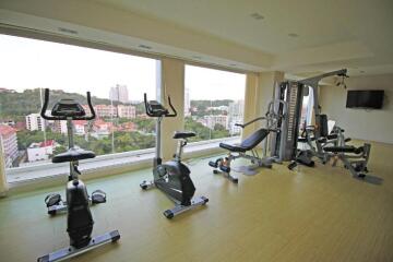 Indoor fitness center with exercise equipment and large windows