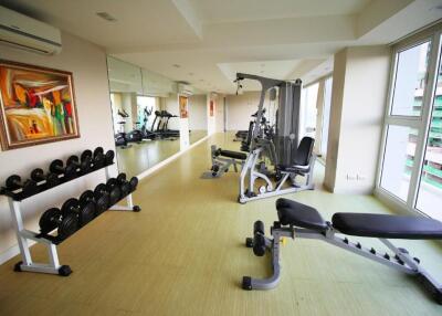 Gym room with various equipment and large windows