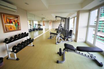Gym room with various equipment and large windows