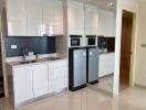 Modern kitchen with stainless steel appliances and white cabinets