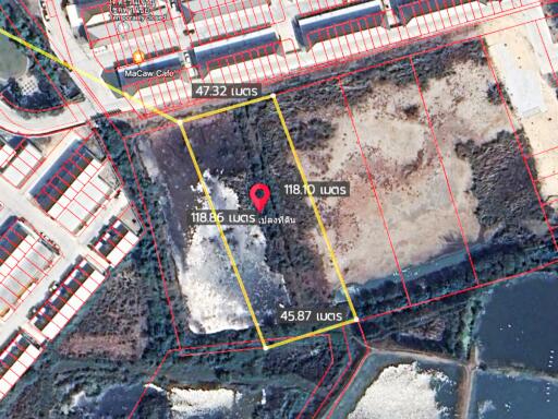 Aerial view of land plots with measurements and pin marker