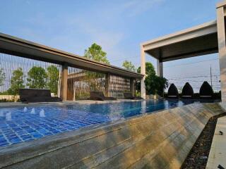 Modern outdoor swimming pool with lounge chairs