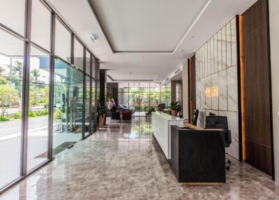 Modern office building lobby with reception desk and glass walls