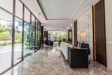 Modern office building lobby with reception desk and glass walls