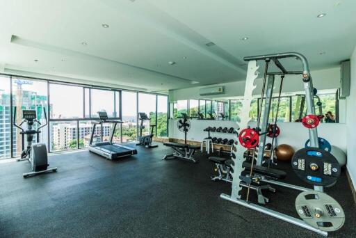 Spacious gym with modern equipment and large windows