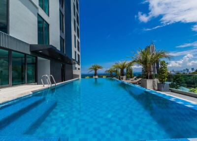 Modern high-rise building with a spacious outdoor swimming pool