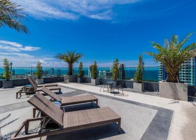 rooftop terrace with lounge chairs and ocean view