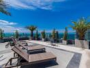 rooftop terrace with lounge chairs and ocean view