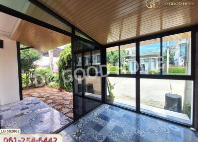 Glass-enclosed balcony with garden view