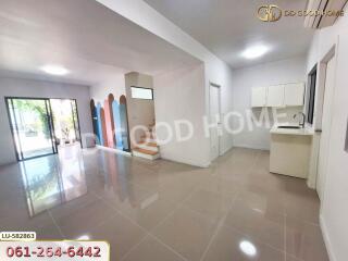 Spacious main living area with kitchen and large windows