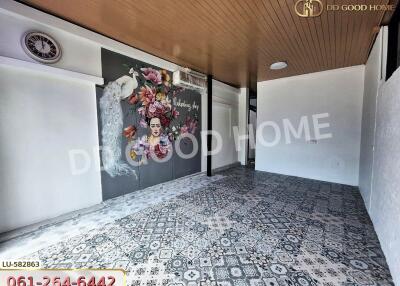 Spacious living room with decorative wall art and patterned flooring