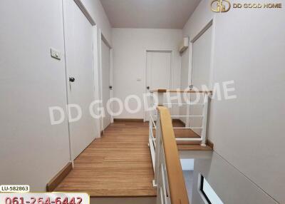 Modern hallway with wooden flooring and white walls