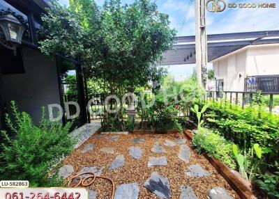 Lush garden with pathway and surrounding greenery