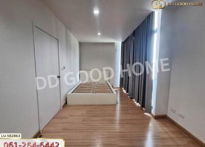 Unfurnished bedroom with wooden flooring and large window