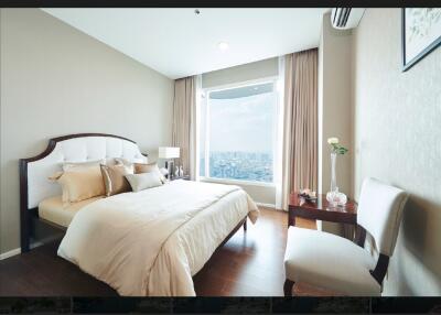 Modern bedroom with a large window overlooking a cityscape