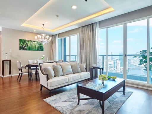 Spacious and bright living room with a view, modern furnishings, and open dining area