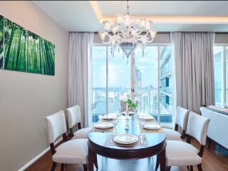 Elegant dining room with chandelier and city view