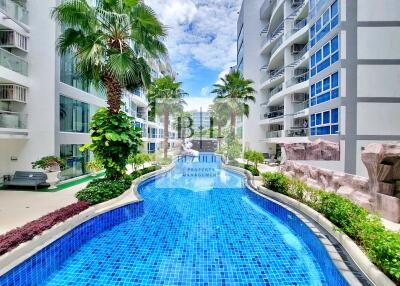 Outdoor pool area with modern apartments