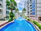 Outdoor pool area with modern apartments