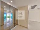 Spacious and bright hallway with mirrored closets