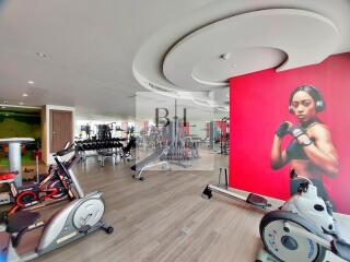 Modern gym equipped with various exercise machines and weights