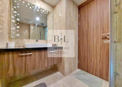 Modern bathroom with wooden accents and large mirror