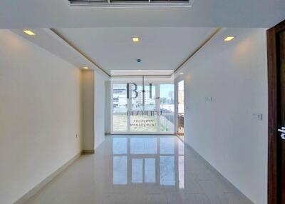 Spacious living room with large window and modern fittings