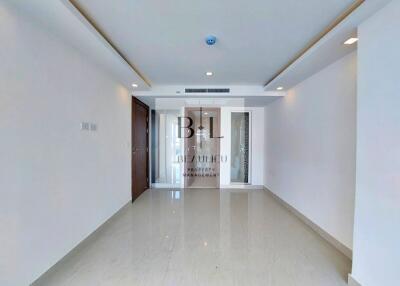 Spacious modern living room with tiled floor and white walls